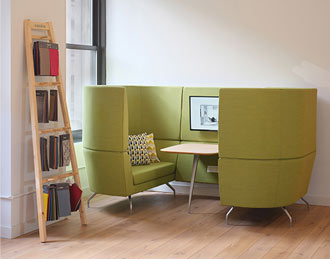 Cwtch high backed sofas facing each other with built-in table and monitor